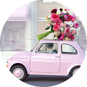 Une voiture rose avec des fleurs sur le toit